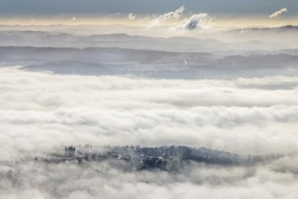Aerial view, residential area in fog with high-rise building, mobile phone antennas in backlight in