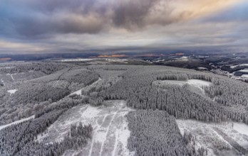Aerial view of the snowy winter landscape of Winterberg in Sauerland in North Rhine-Westphalia,