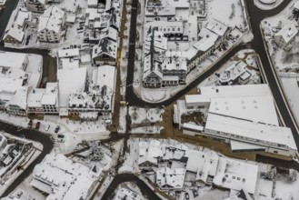 Aerial view of the snowy winter landscape of Winterberg with deserted streets at the market in the