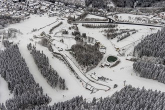 Aerial view of the snowy winter landscape of Winterberg with the St. Georg ski jump in the