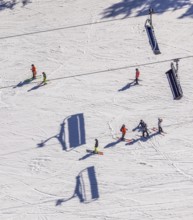 Skiers on ski slope and chairlift, Winterberg, Sauerland, North Rhine-Westphalia, Germany, DE,