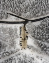 Aerial view of the snowy winter landscape of Winterberg with car park Helleplatz at Kahlen Asten in
