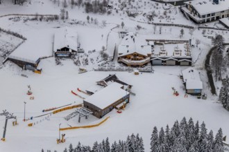 Aerial view of the snowy winter landscape of Winterberg with deserted ski lifts and slopes during