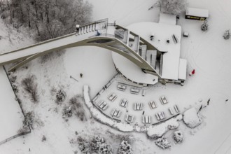 Aerial view of the snowy winter landscape of Winterberg with the St. Georg ski jump in the