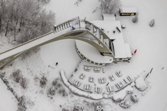 Aerial view of the snowy winter landscape of Winterberg with the St. Georg ski jump in the