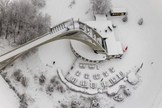 Aerial view of the snowy winter landscape of Winterberg with the St. Georg ski jump in the