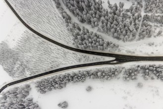 Aerial view of the snowy winter landscape of Winterberg with winding roads and paths with a