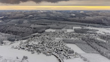 Aerial view of the snowy winter landscape of Winterberg with Altastenberg district in Sauerland in