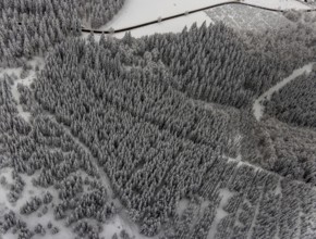 Aerial view of the snowy winter landscape of Winterberg with winding roads and paths in the