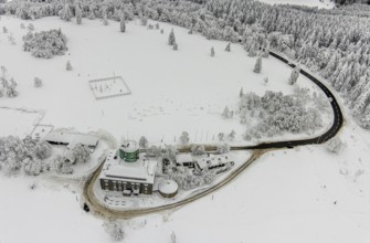 Aerial view of the snowy winter landscape of Winterberg am Kahlen Asten with Astenturm during