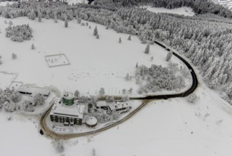 Aerial view of the snowy winter landscape of Winterberg am Kahlen Asten with Astenturm during