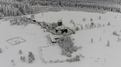 Aerial view of the snowy winter landscape of Winterberg am Kahlen Asten with Astenturm during