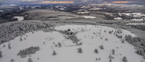 Aerial view of the snowy winter landscape of Winterberg am Kahlen Asten with Astenturm during