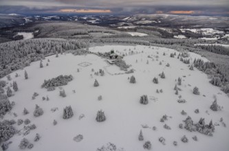 Aerial view of the snowy winter landscape of Winterberg am Kahlen Asten with Astenturm during