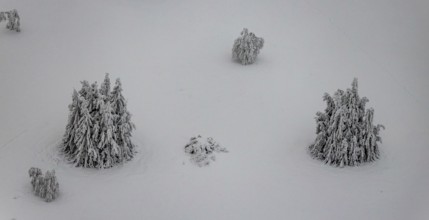 Aerial view of the snowy winter landscape of Winterberg below the Kahler Asten with snow-covered