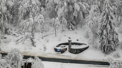 Aerial view of the snowy winter landscape of Winterberg below the Kahler Asten with snow-covered