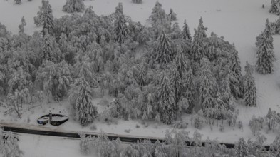 Aerial view of the snowy winter landscape of Winterberg below the Kahler Asten with snow-covered