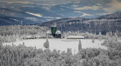 Aerial view of the snowy winter landscape of Winterberg am Kahlen Asten with Astenturm during