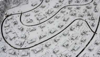 Aerial view of the snowy winter landscape of Winterberg with the deserted Landal Winterberg holiday