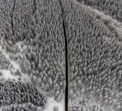 Aerial view of the snowy winter landscape of Winterberg with winding roads and paths in the