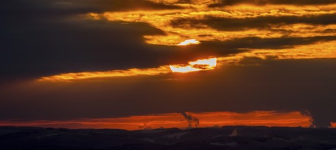 Aerial view of the sunset with a view over the snowy winter landscape from Winterberg to the