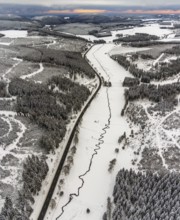 Aerial view of the Ruhr valley with the meandering Ruhr as a stream in the snowy winter landscape