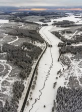Aerial view of the Ruhr valley with the meandering Ruhr as a stream in the snowy winter landscape