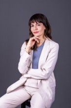 Confident professional businesswoman with her hand on her chin