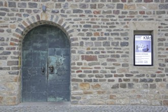 Door and entrance to the art museum, metal door, banner, stone wall, art museum, Kloster Unser