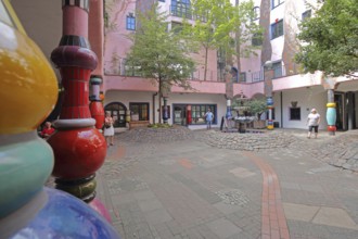 Colourful columns in the inner courtyard with fountain, Green Citadel, Hundertwasser House,