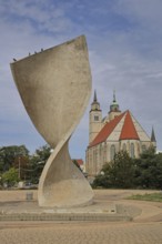 Sculpture Flag monument by Joachim Sendler 1974, late Romanesque St. Johannis Church, concrete,