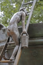 Detail with male figure with bucket climbing up a rung ladder at the Faun Fountain by Heinrich Apel