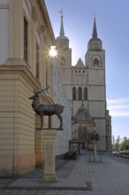 Stag column with stag statue and St John's Church in the backlight, stag statue, Old Town Hall, Old