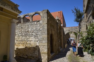 Narrow alley in an old town with two people and old buildings, Kahal Shalom Synagogue, Sephardic