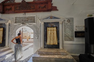 A woman enters a synagogue through a decorative arch, Kahal Shalom Synagogue, Sephardic Synagogue,