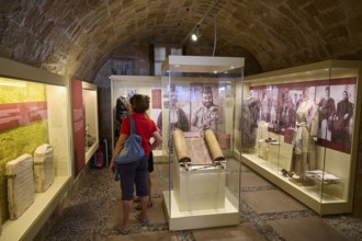 Museum exhibition with manuscripts and visitors in historic vaults, Kahal Shalom Synagogue,