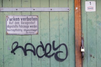 Photograph of a no parking sign attached to a wooden garage door, Hanover, Lower Saxony, Germany