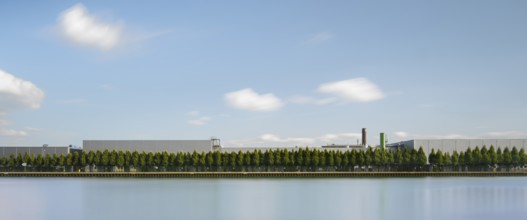 View across the Mittelland Canal to an industrial building with trees growing in front of it, long