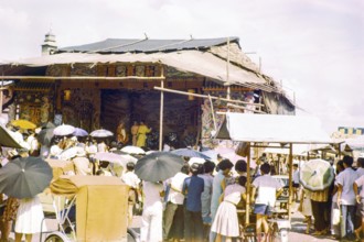 Audience watching Chinese theatre performance at the old market, Johor Bahru, Johor, Malaya,