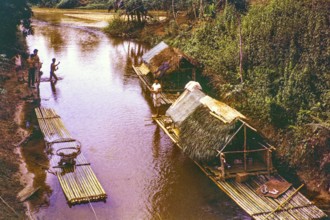 People living in homes on river house rafts, Pahnag river, Bentong district, Malaya, Malaysia,