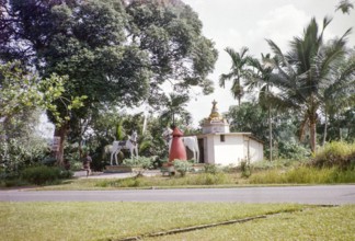 Statues of large white horses stand outside Kutherai kovil unregistered Hindu temple shrine,
