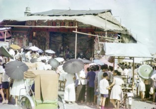 Audience watching Chinese theatre performance at the old market, Johor Bahru, Johor, Malaya,