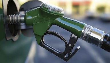 Green Gas Pump Spilling Fuel In A Fast Flow, Causing A Messy Situation At The Gas Station. Spillage