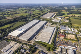 Aerial view of an extensive industrial area with many warehouses and surrounding fields, aerial