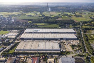Large area with warehouses in the middle of a rural landscape under a sunny sky, aerial view Werl