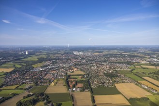 Aerial view of a town with surrounding fields and forest under a blue sky, aerial view Werl