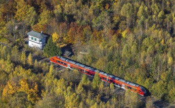 Aerial view, S-Bahn at a guard house in autumn forest in the district of Bigge in Olsberg,