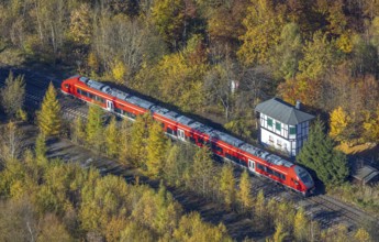 Aerial view, S-Bahn at a guard house in autumn forest in the district of Bigge in Olsberg,