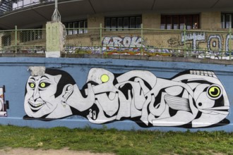 Stylised graffiti artwork on a wall with abstract shapes and faces Urania Ringstraße Vienna Austria