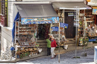 A busy market stall with souvenirs and signs in a lively street scene, The witches' market of La